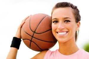 Teens and adults can participates in sports while wearing braces by wearing a mouthguard. 